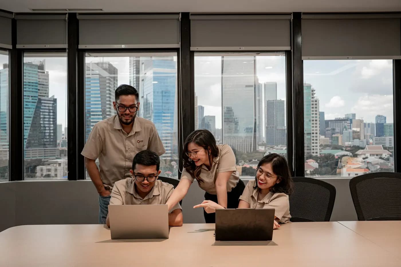 An agency team reviewing a client project together on laptops